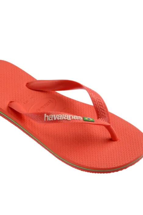 A single Havaianas flip-flop sandal in a vibrant coral red color, shown from a three-quarters perspective on a plain white background.