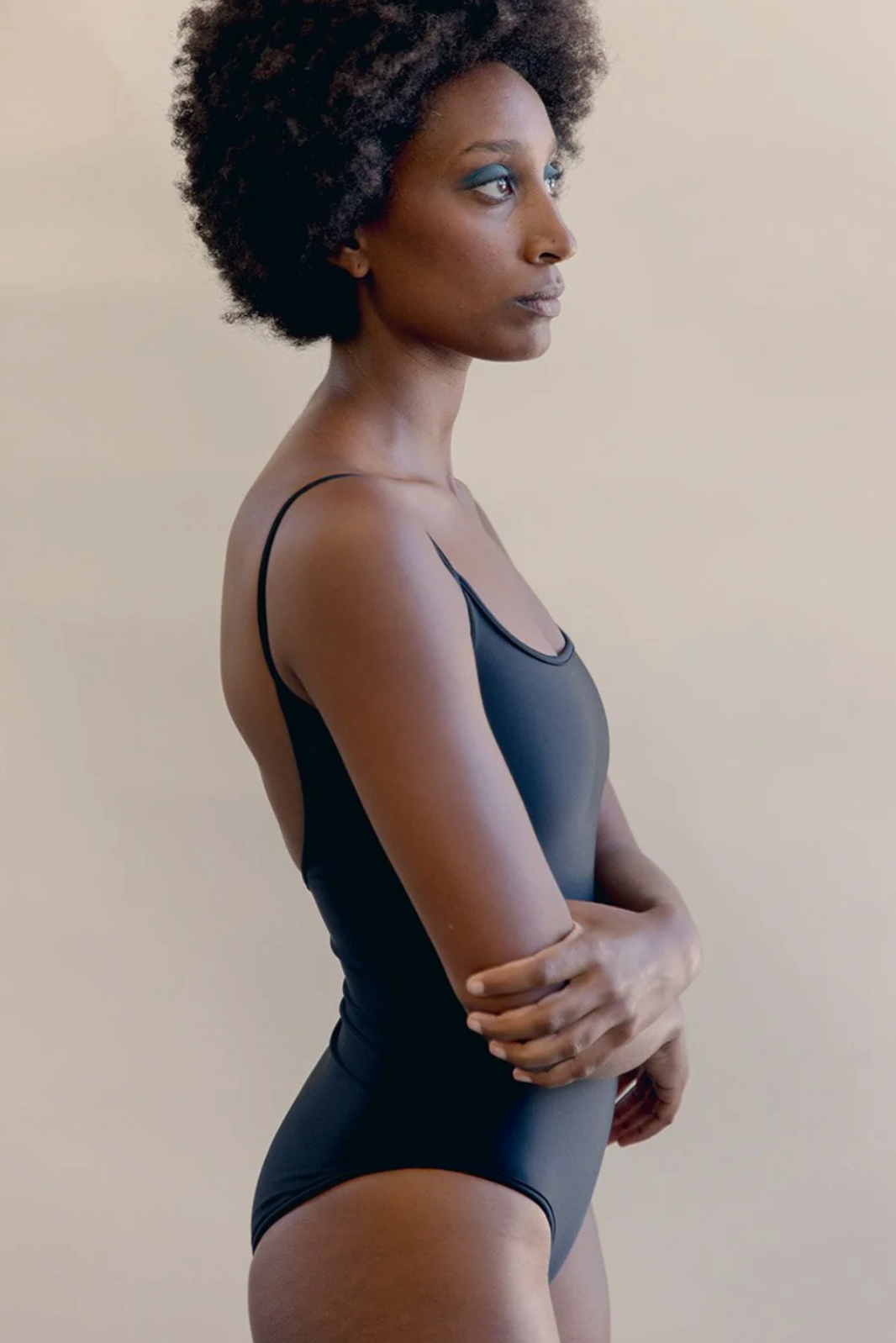 Side view of model wearing Nu Swim black Noodle Suit - East Coast General