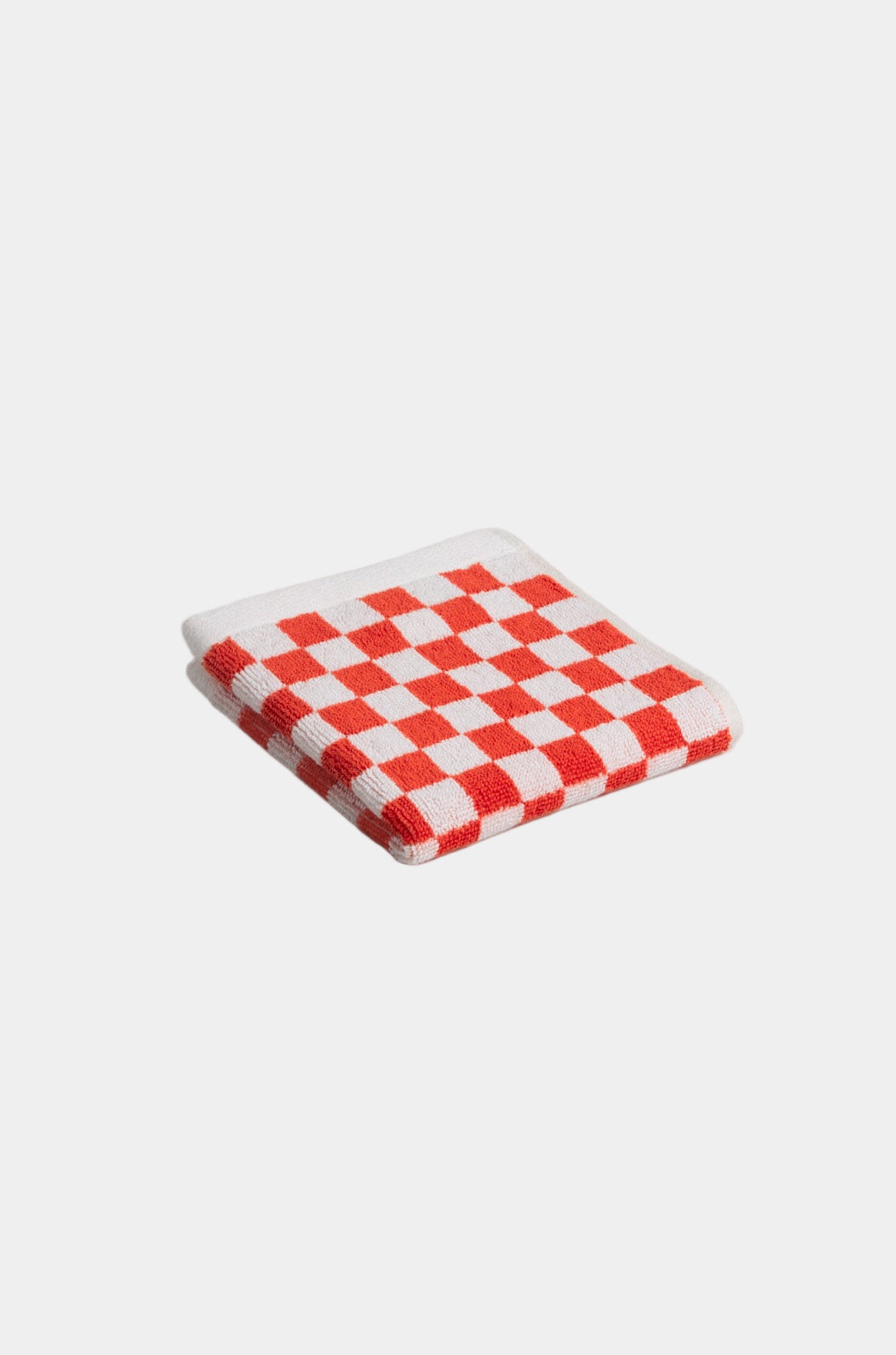 Red and white checkered face cloth on a white  background
