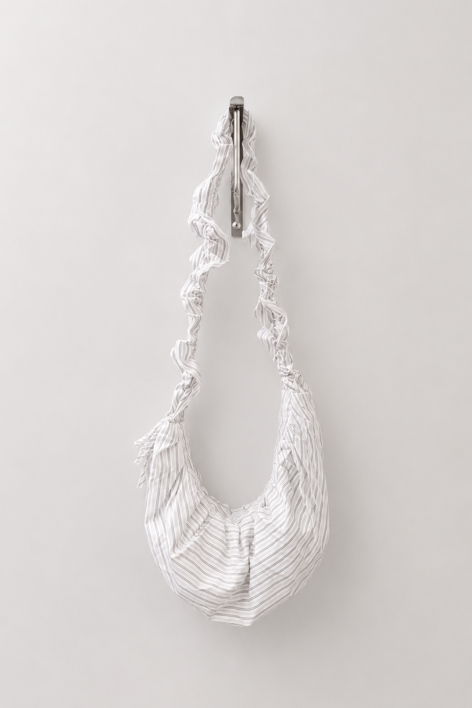 Stripe ruched bag hanging on silver hook