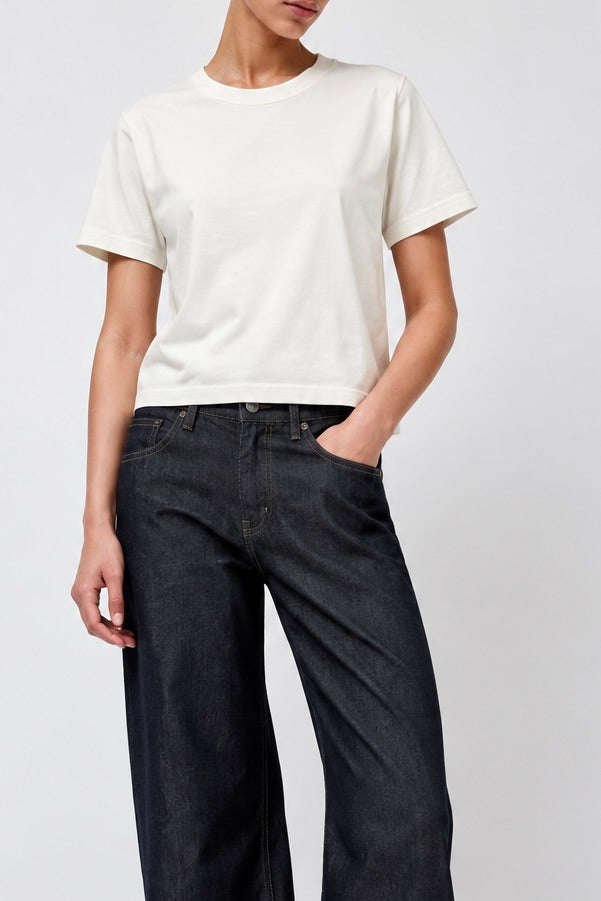A model the Sunray Sportswear Hi'aka t-shirt in Off White styled with B Sides Floppy Jeans