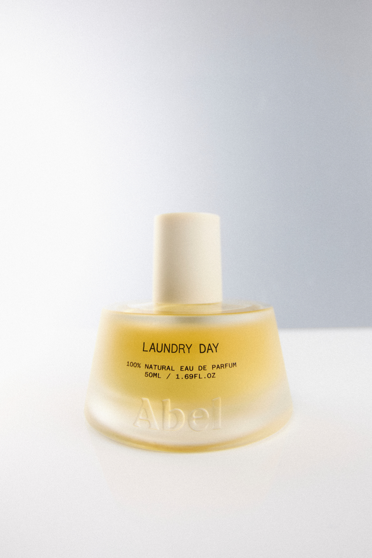 Perfume bottle labeled 'Laundry Day' on a white background