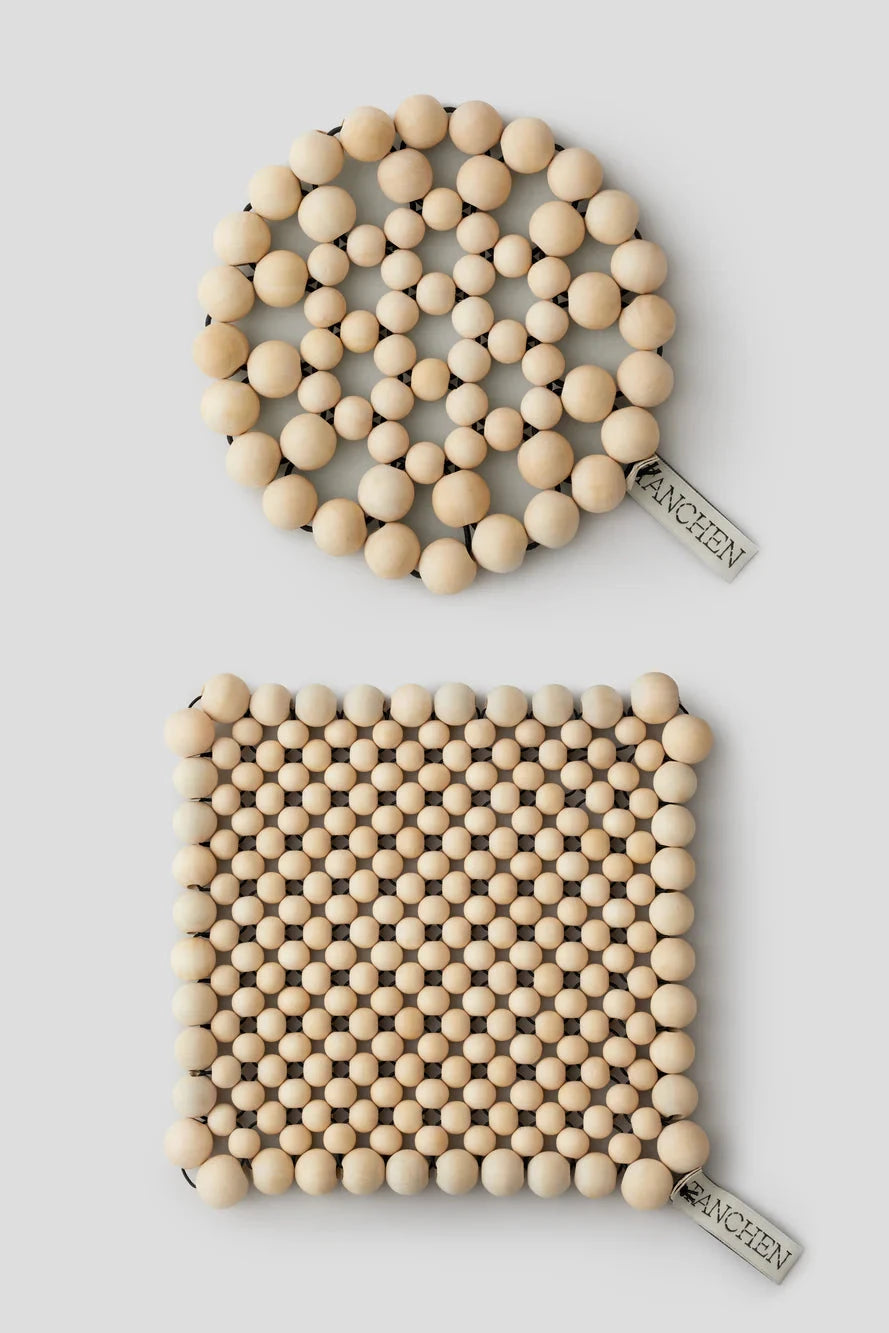 Two wooden bead coasters with 'Fancian' branding on a light gray background