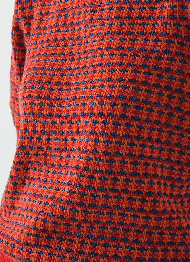 Close-up of a red fabric with blue pattern