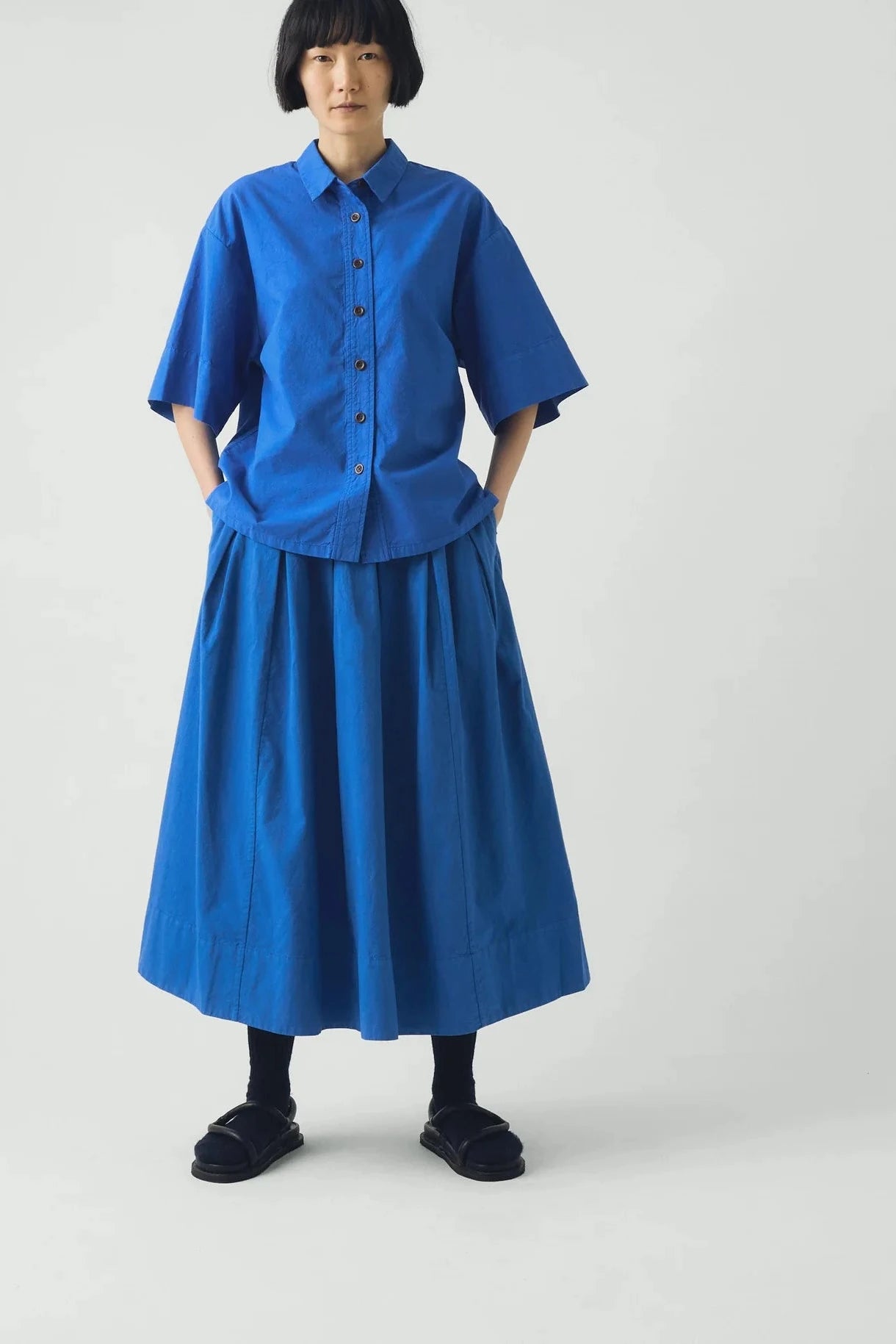 Person wearing a blue outfit on a white background