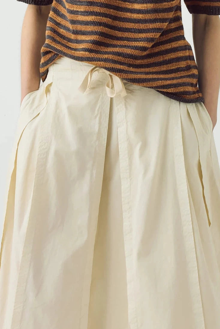 Deep detail close-up of the crisp cotton linen texture on the TOAST skirt and the relaxed knit ribbing
