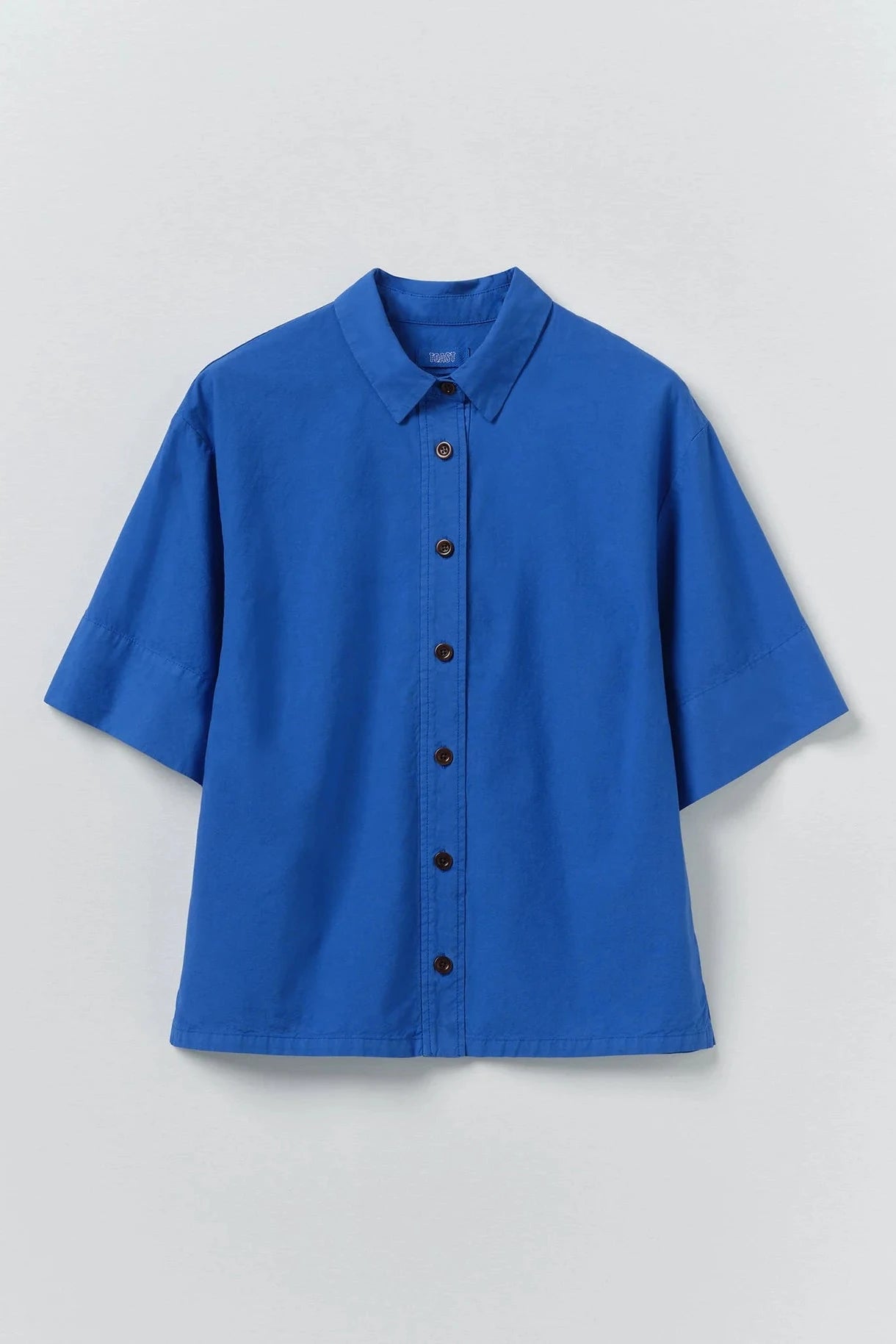 Blue shirt with buttons on a light gray background