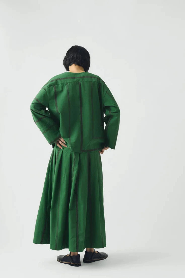 Person wearing a green outfit on a white background