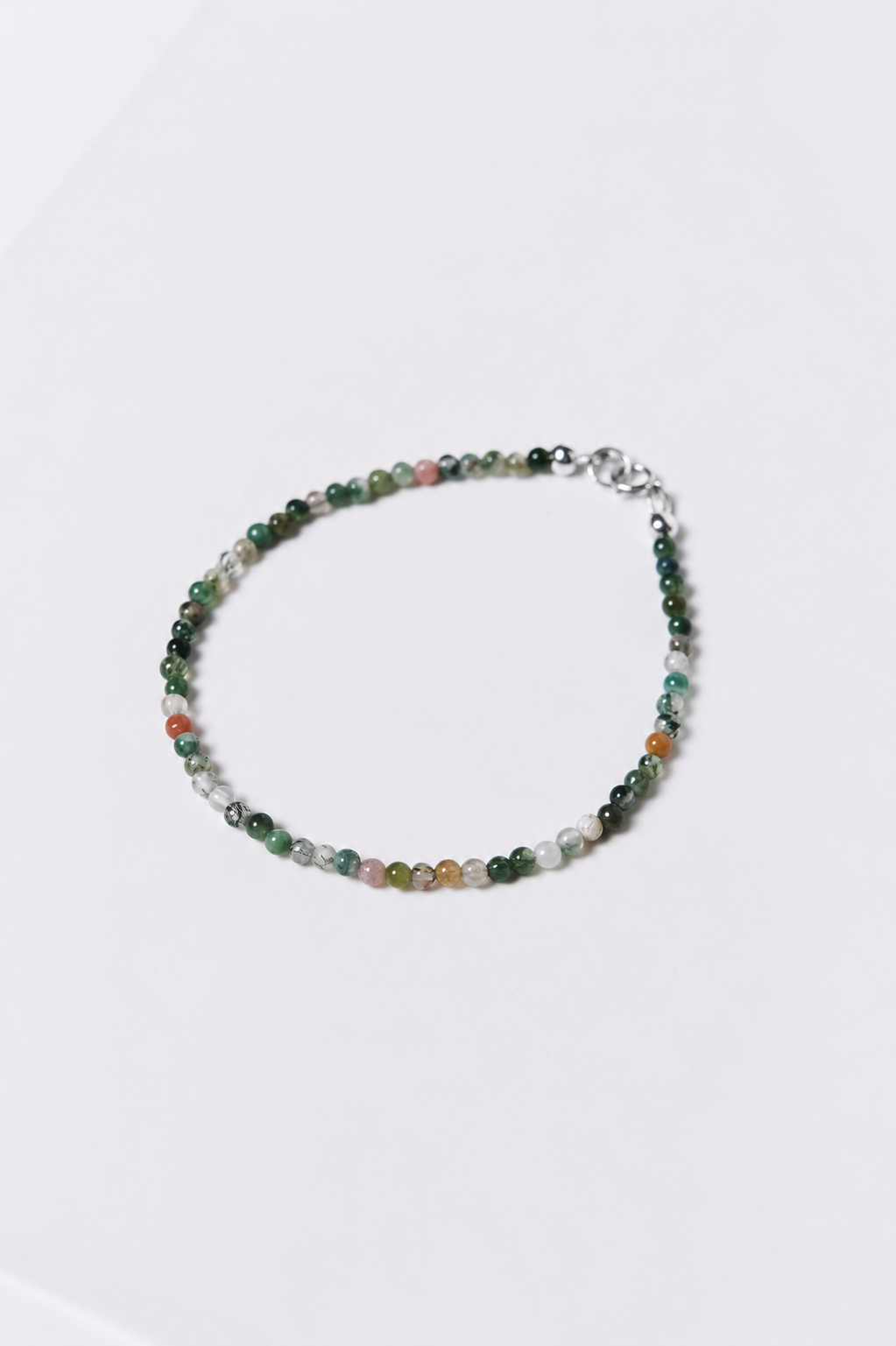 Beaded bracelet with multicolored beads on a white background