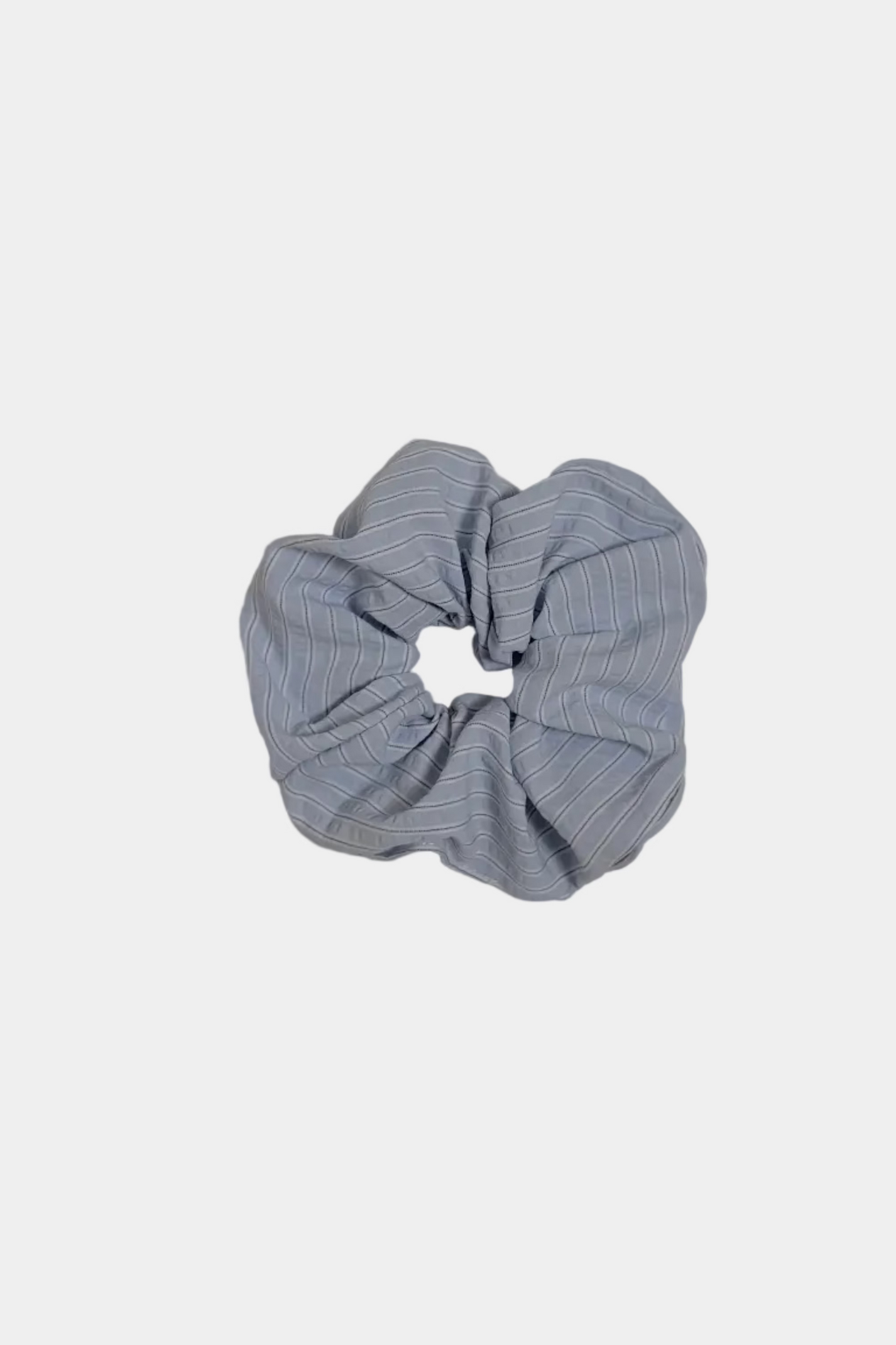 Blue scrunchie on a light gray surface