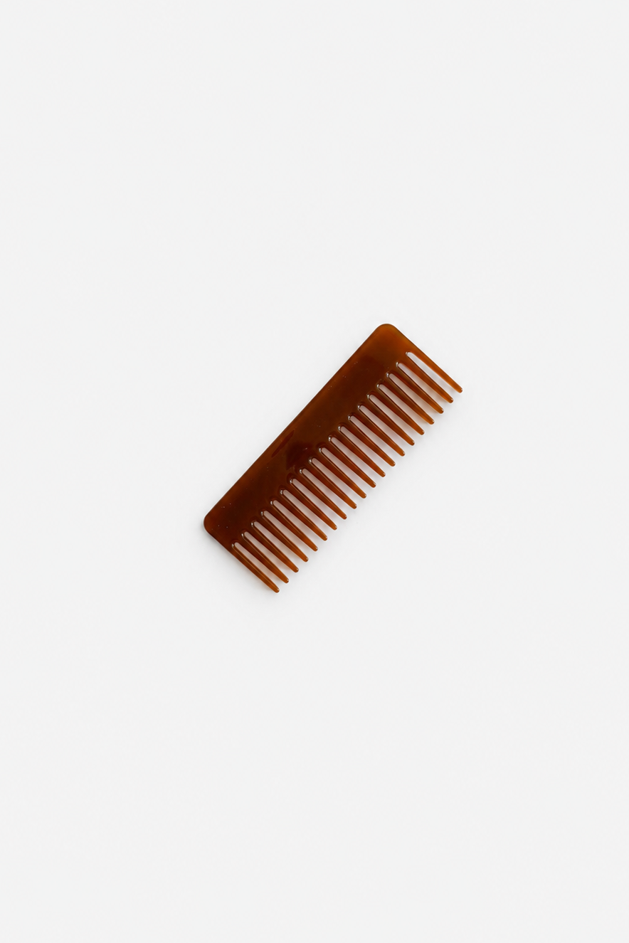 Amber brown comb displayed on a light grey background.