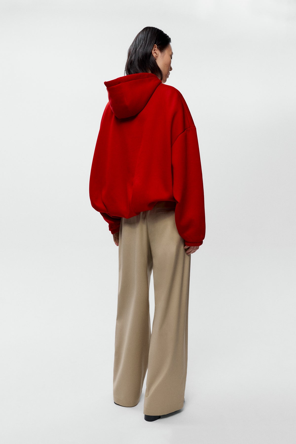 Rear view of model wearing Cordera red balloon hoodie with Cordera Low rise virgin wool pants - East Coast General