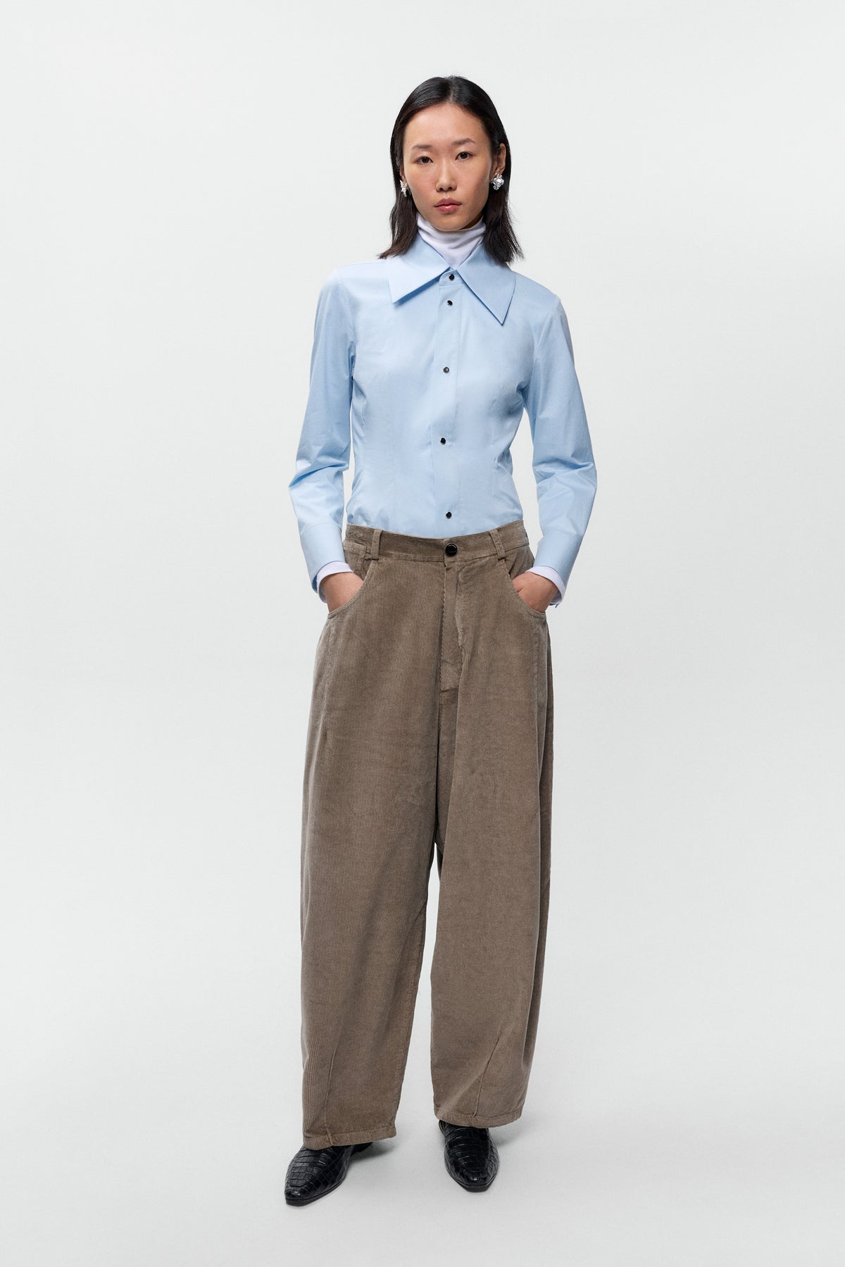 Front view of model wearing Cordera corduroy baggy pants in sage with wide leg fit - East Coast General