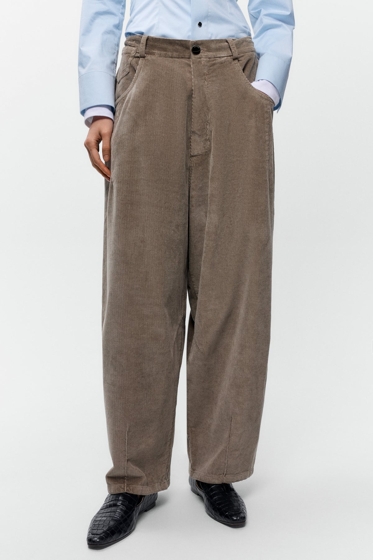 Close up Front view of model wearing Cordera corduroy baggy pants in sage with wide leg fit - East Coast General