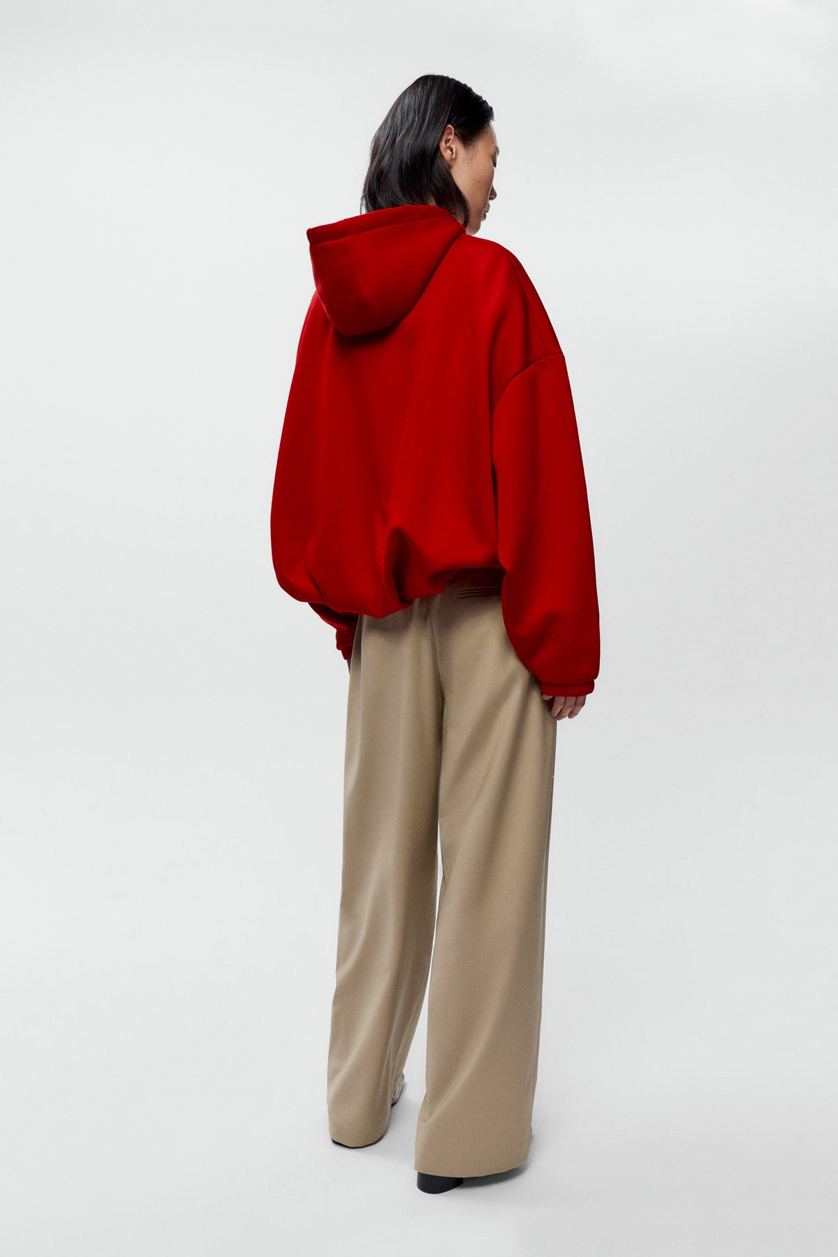 Back view of model wearing Cordera low rise virgin wool pants in beige with straight leg fit - East Coast General