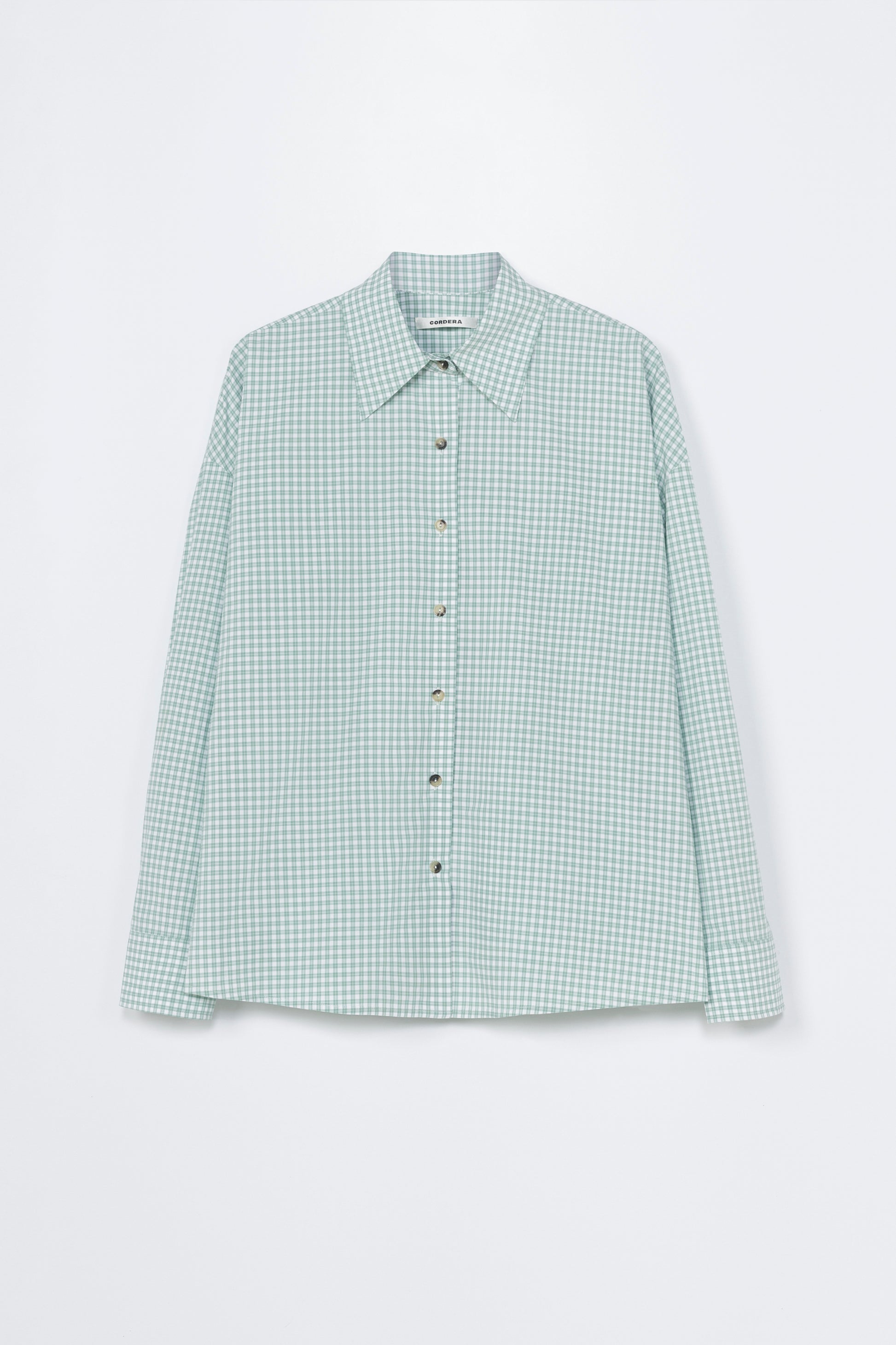Green and white checkered shirt on a light gray background
