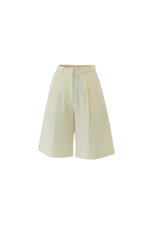 Butter yellow Bermuda tailored shorts, with double pleat detail on a light grey background