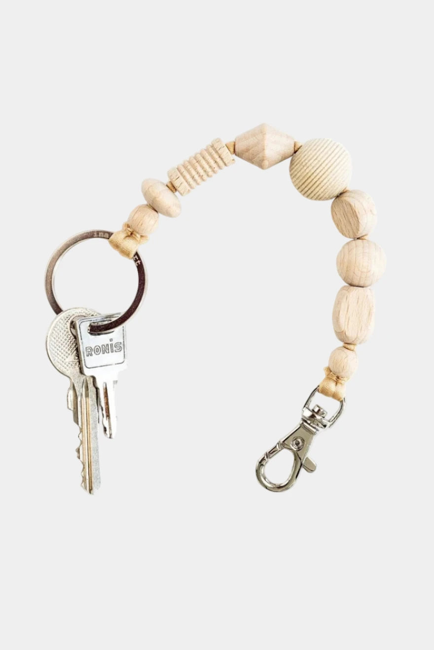 Keychain with wooden beads and keys on a white background
