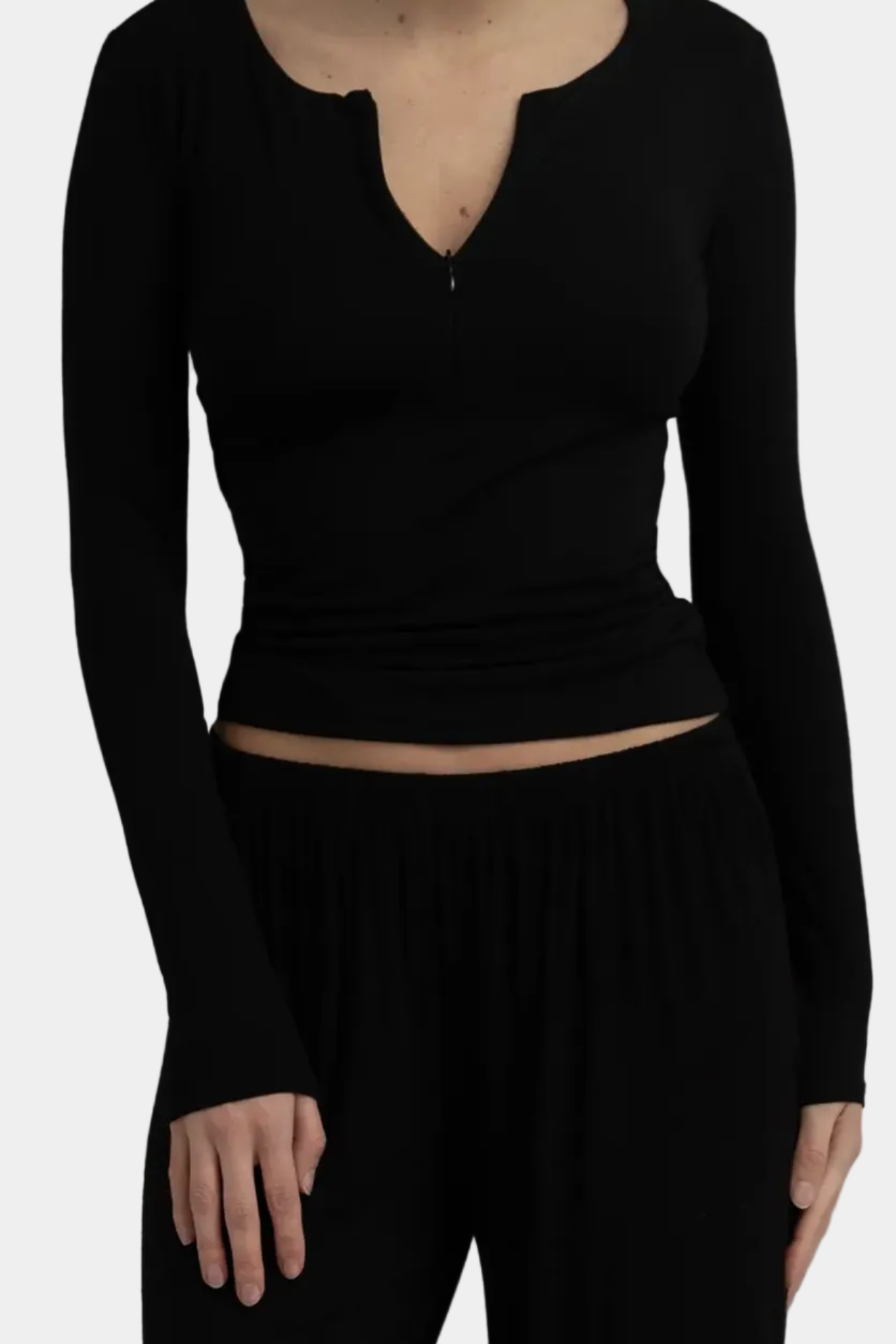 Model wearing KYE Intimates Recline Half Zip in Black soft bamboo pullover front view