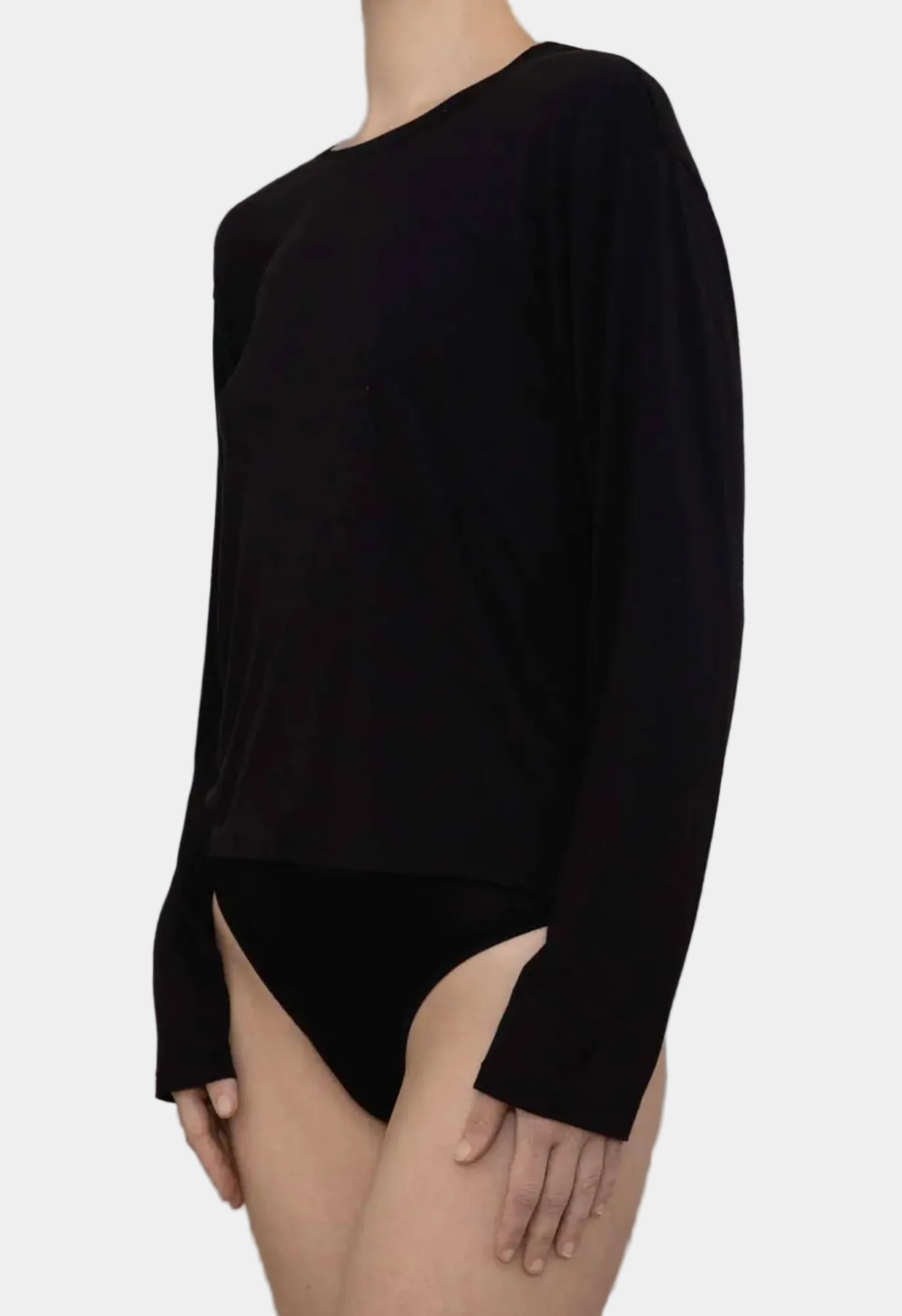 Side view showing draped fit and long sleeves on KYE Intimates Black Relaxed Long Sleeve
