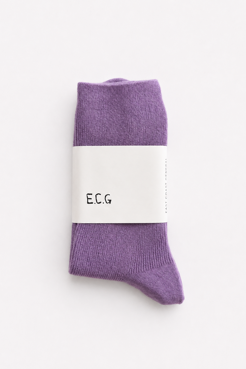 A pair of purple ribbed cotton socks wrapped in a white paper band with the brand name 'E.C.G - East Coast General