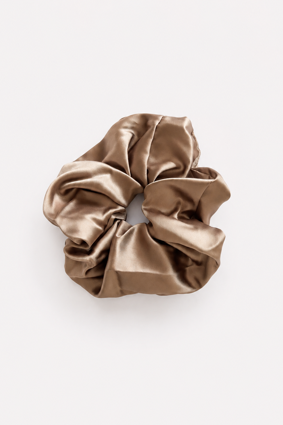 A single satin hair scrunchie in a warm taupe-brown color, photographed from directly above on a clean white background - East Coast General