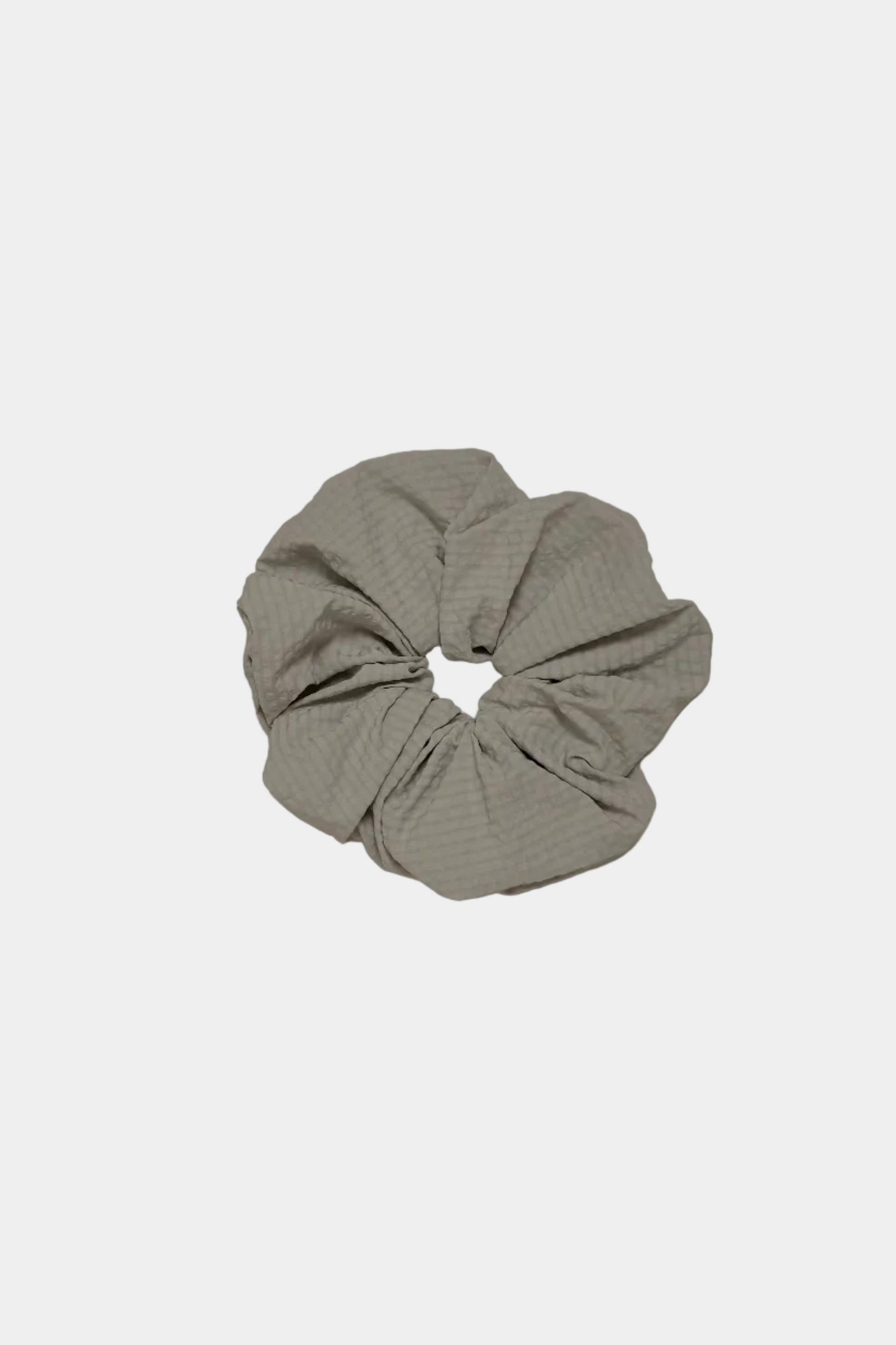 Sage scrunchie on a light gray background