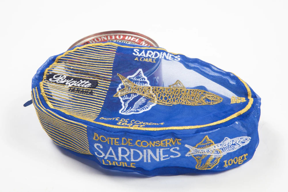 Blue and gold can of sardines organza pouch on a white background