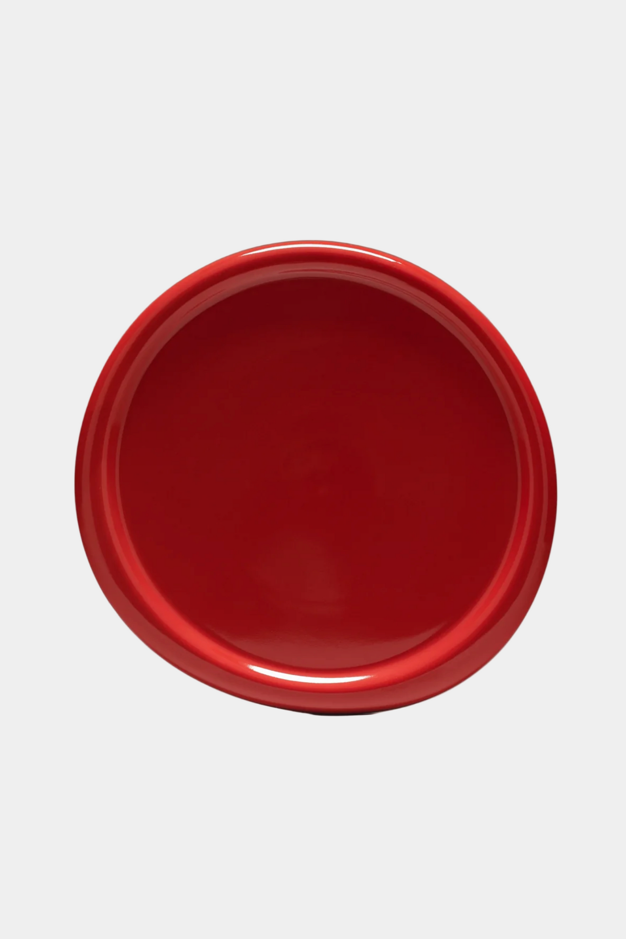 Red ceramic bowl on a white background