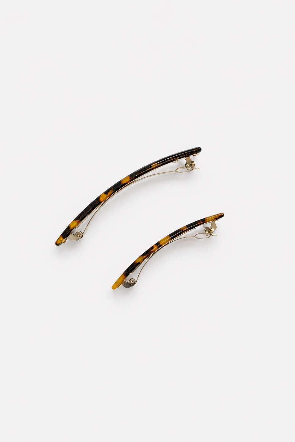 Two curved tortoiseshell hair claw clips with silver-tone metal spring clips, displayed on a clean white background - East Coast General