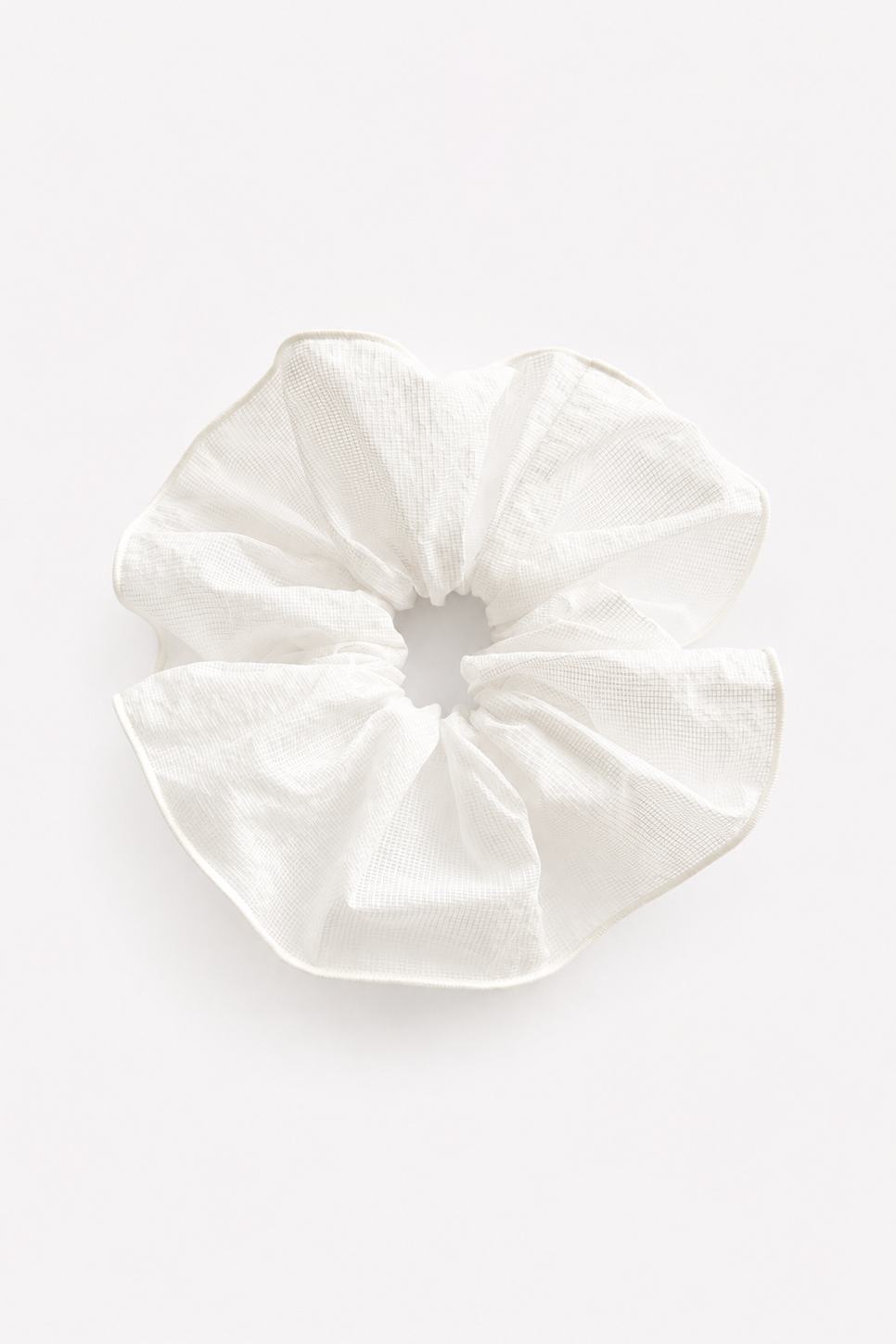 A single white checked fabric scrunchie with a textured, crinkled linen-like surface, photographed from directly above on a clean white background - East Coast General